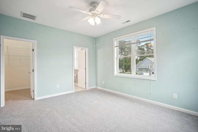 34637 Megan Ct, Lewes, DE 19958 - unfurnished bedroom with a walk in closet, baseboards, carpet flooring, ensuite bathroom, and a ceiling fan
