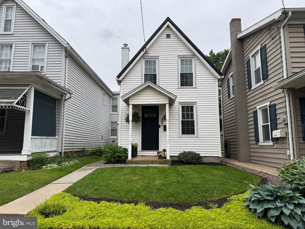 360 E Main St, Lititz, PA 17543 - view of front of house featuring a front lawn and a chimney