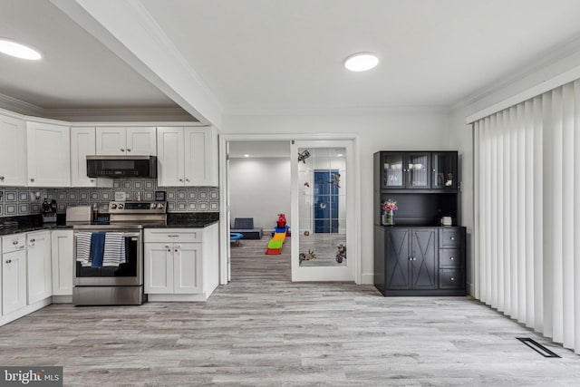 76 Torrington Ln, Willingboro, NJ 08046 - kitchen with stainless steel range with electric cooktop, ornamental molding, dark countertops, and white cabinets