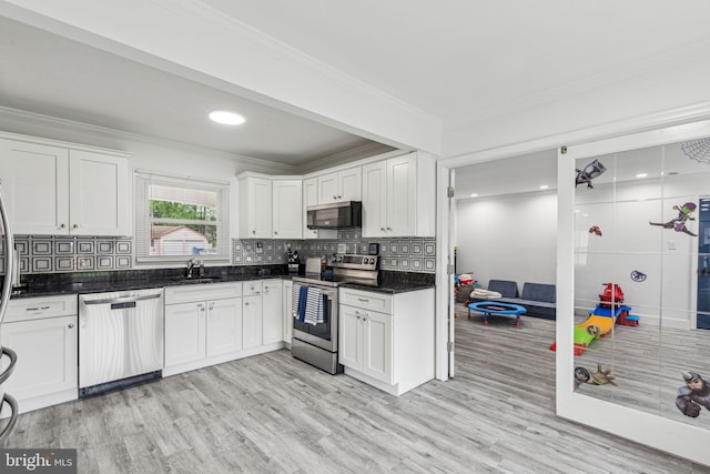 76 Torrington Ln, Willingboro, NJ 08046 - kitchen featuring appliances with stainless steel finishes, a sink, crown molding, light wood-style flooring, and white cabinetry