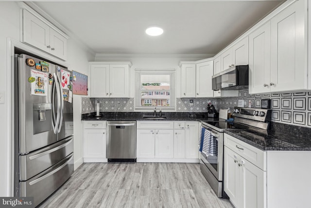 76 Torrington Ln, Willingboro, NJ 08046 - kitchen featuring appliances with stainless steel finishes, a sink, white cabinets, crown molding, and tasteful backsplash