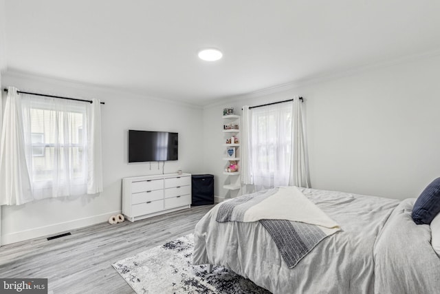 76 Torrington Ln, Willingboro, NJ 08046 - bedroom featuring crown molding, multiple windows, light wood-style floors, and baseboards