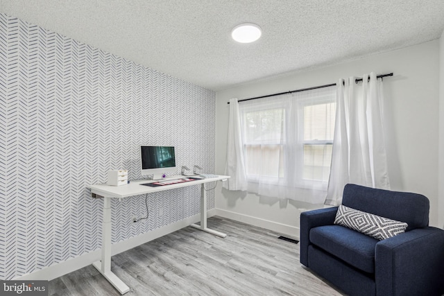 76 Torrington Ln, Willingboro, NJ 08046 - office space with an accent wall, a textured ceiling, baseboards, wallpapered walls, and light wood-type flooring