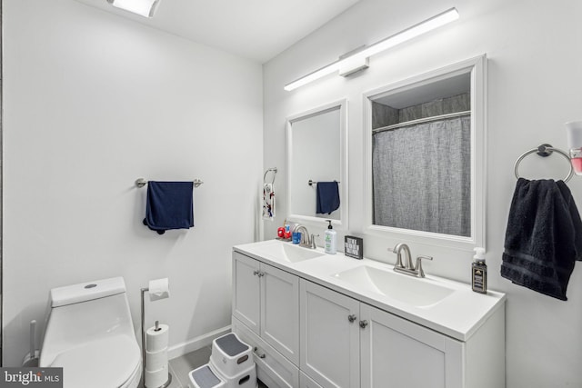 76 Torrington Ln, Willingboro, NJ 08046 - bathroom with toilet, double vanity, and baseboards