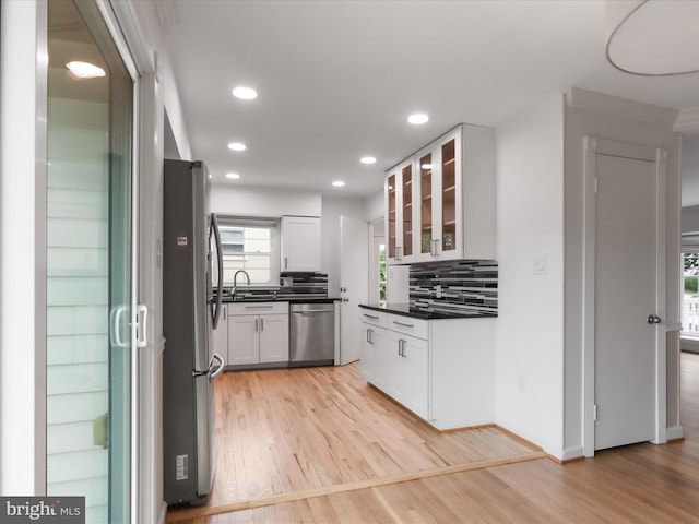 4102 Elizabeth St, Rockville, MD 20853 - kitchen featuring appliances with stainless steel finishes, a sink, dark countertops, light wood-type flooring, and recessed lighting