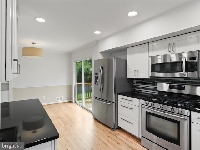 4102 Elizabeth St, Rockville, MD 20853 - kitchen featuring appliances with stainless steel finishes, dark countertops, white cabinetry, light wood finished floors, and recessed lighting