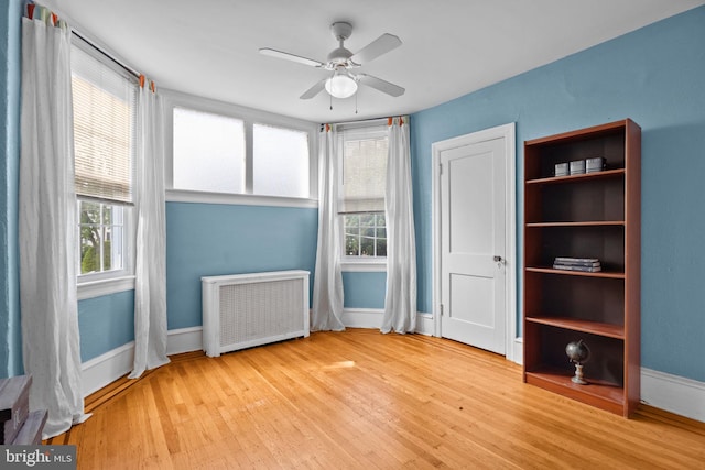 917 Foulkrod St, Philadelphia, PA 19124 - unfurnished bedroom with radiator, multiple windows, wood finished floors, and baseboards