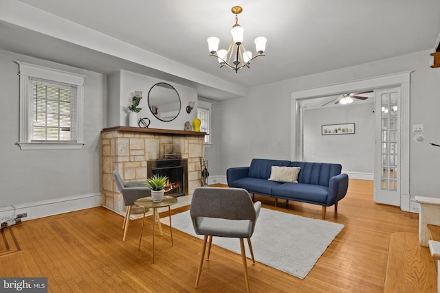 917 Foulkrod St, Philadelphia, PA 19124 - living area with wood finished floors, a fireplace, a chandelier, and ceiling fan