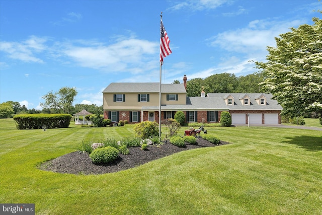 7 Taylor Ln, Doylestown, PA 18902 - view of front of home featuring brick siding, a front yard, a chimney, driveway, and an attached garage