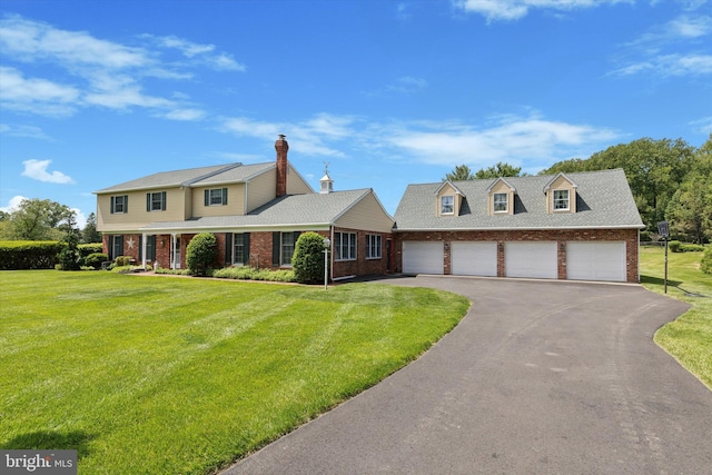 7 Taylor Ln, Doylestown, PA 18902 - view of front of house with brick siding, driveway, a front yard, and an attached garage