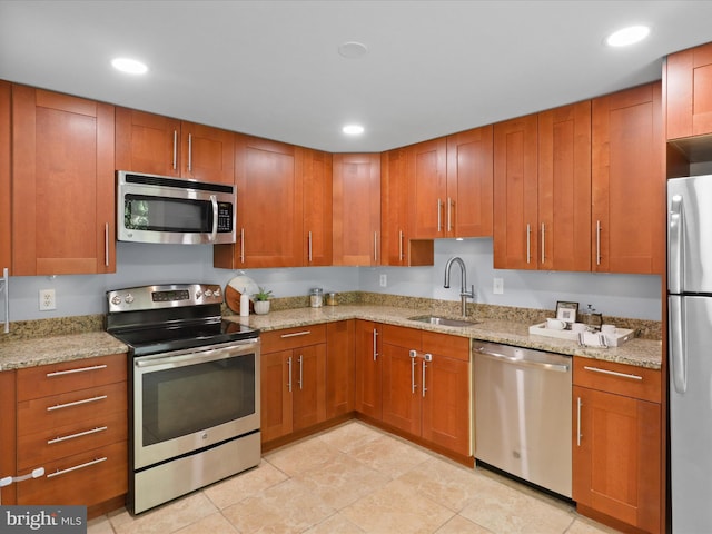 2934 Everleigh Way, Fairfax, VA 22031 - kitchen with stainless steel appliances, a sink, brown cabinets, light stone countertops, and recessed lighting