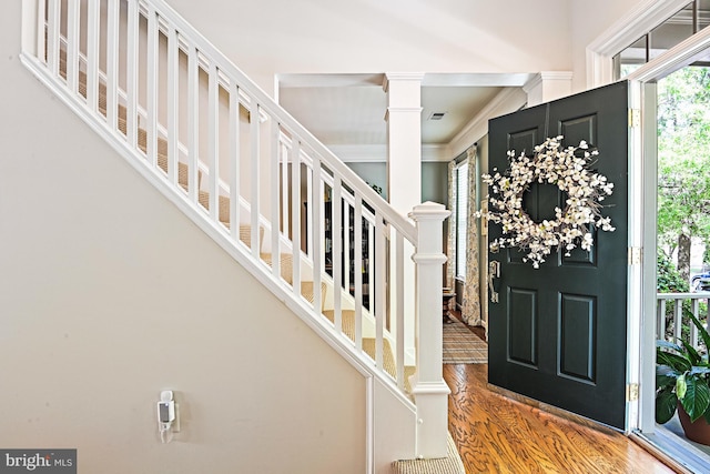 20337 Charter Oak Dr, Ashburn, VA 20147 - entrance foyer featuring wood finished floors, decorative columns, stairs, and ornamental molding
