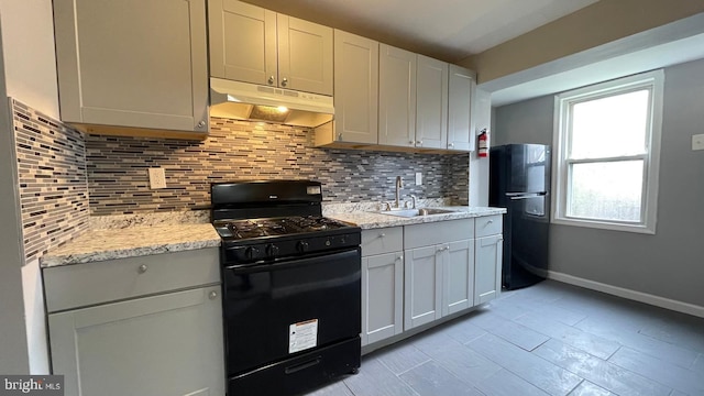 1206 Morton Ave, Chester, PA 19013 - kitchen featuring black appliances, under cabinet range hood, a sink, and tasteful backsplash