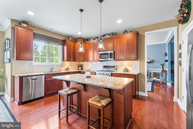 310 Windsor Rd, Mullica Hill, NJ 08062 - kitchen featuring stainless steel appliances, a sink, dark wood finished floors, a kitchen island, and a breakfast bar area