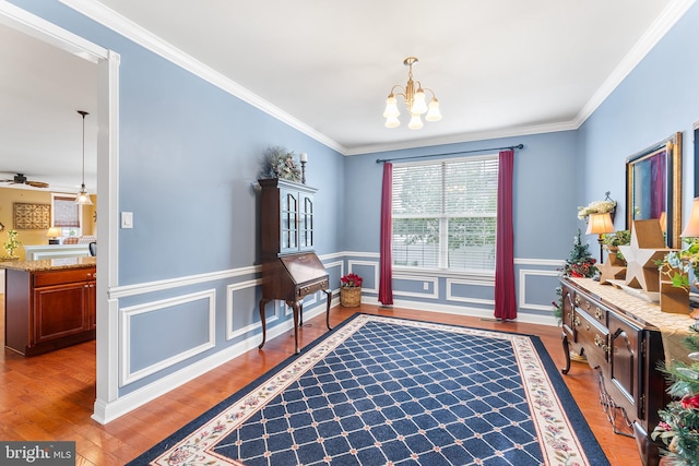 310 Windsor Rd, Mullica Hill, NJ 08062 - living area featuring a chandelier, a wainscoted wall, wood finished floors, crown molding, and a ceiling fan