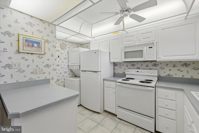 605 Chesapeake House Rd Unit 605N, Bethany Beach, DE 19930 - kitchen with white appliances, wallpapered walls, a ceiling fan, white cabinets, and light countertops