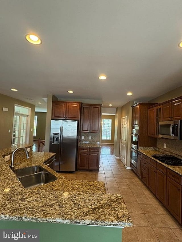 1719 Idlewild Blvd, Fredericksburg, VA 22401 - kitchen featuring stainless steel appliances, a sink, light tile patterned floors, tasteful backsplash, and recessed lighting