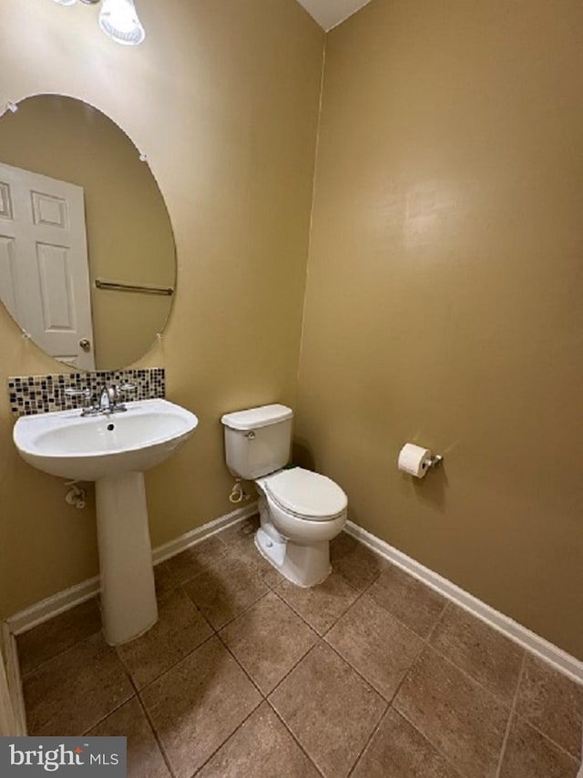 1719 Idlewild Blvd, Fredericksburg, VA 22401 - half bath featuring toilet, tile patterned floors, baseboards, tasteful backsplash, and a sink