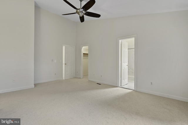 4714 Major Ct, Alexandria, VA 22312 - unfurnished bedroom with light colored carpet, a walk in closet, baseboards, connected bathroom, and lofted ceiling