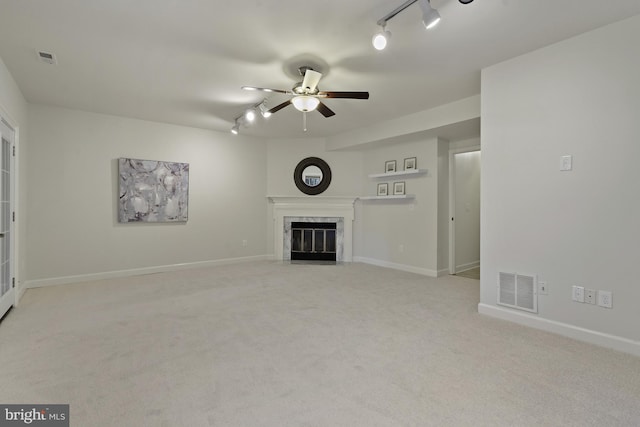 4714 Major Ct, Alexandria, VA 22312 - unfurnished living room with rail lighting, ceiling fan, a premium fireplace, and carpet floors