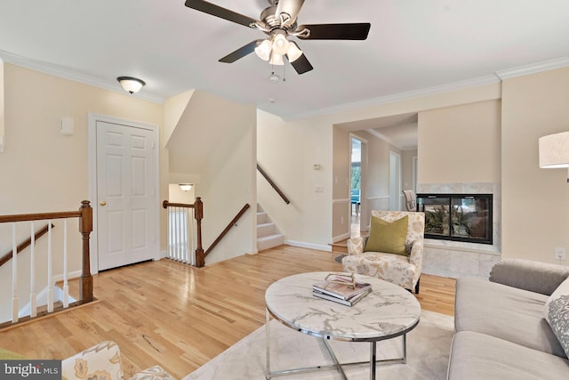 4714 Major Ct, Alexandria, VA 22312 - living area featuring light wood-style floors, ornamental molding, a high end fireplace, ceiling fan, and stairs