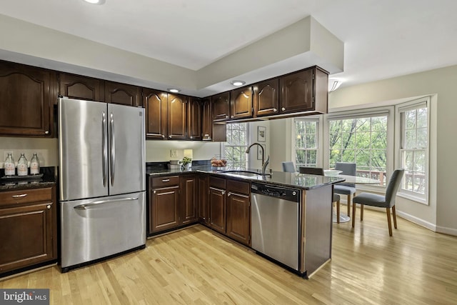 4714 Major Ct, Alexandria, VA 22312 - kitchen featuring appliances with stainless steel finishes, a sink, light wood-style flooring, dark brown cabinets, and recessed lighting