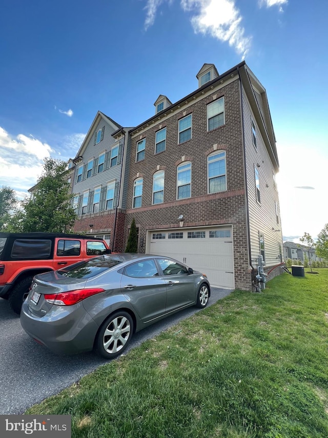 view of property with an attached garage and central air condition unit