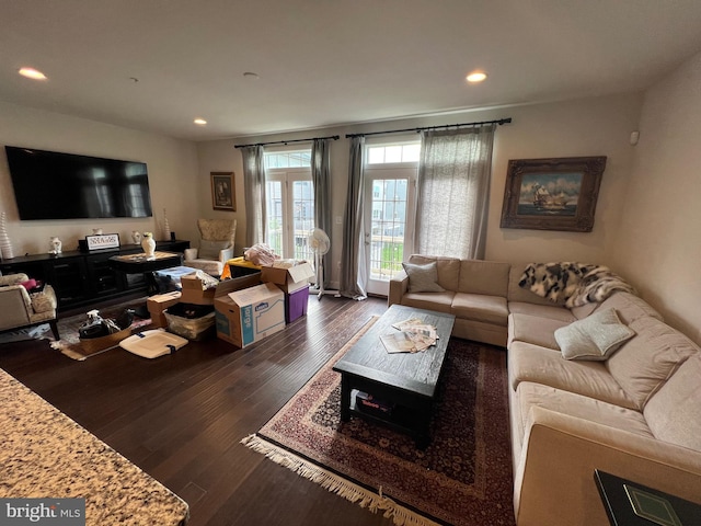 living room featuring dark wood-type flooring and recessed lighting