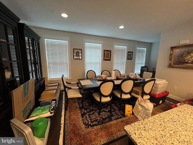 dining space featuring baseboards, recessed lighting, healthy amount of natural light, and wood finished floors