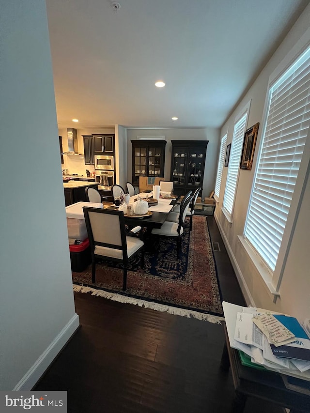 dining room with baseboards, recessed lighting, and dark wood-style floors