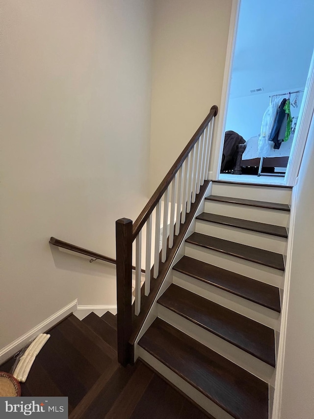 staircase featuring wood finished floors