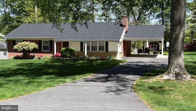 7 Tudor Ln, Bel Air, MD 21015 - view of front of home featuring brick siding, a chimney, driveway, a shingled roof, and a front yard