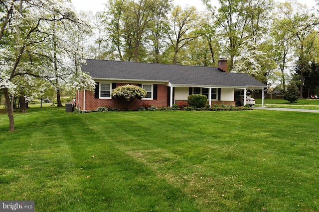 7 Tudor Ln, Bel Air, MD 21015 - ranch-style home featuring brick siding, a chimney, a front lawn, central AC, and a carport