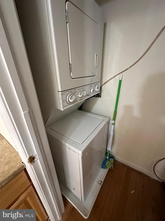 1844 W Master St, Philadelphia, PA 19121 - laundry room featuring stacked washer and clothes dryer, wood finished floors, and baseboards