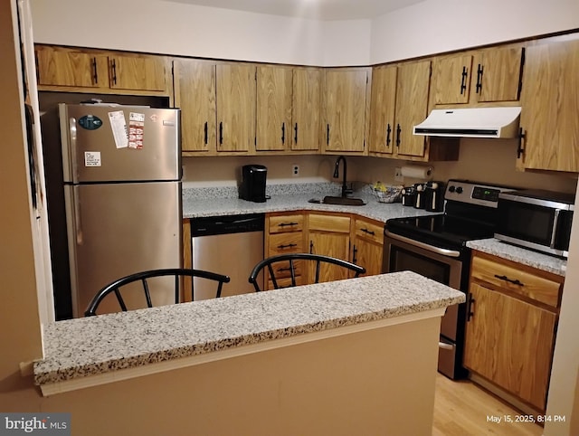 28B W Bluebell Ln, Mount Laurel, NJ 08054 - kitchen featuring ventilation hood, appliances with stainless steel finishes, a sink, light wood-style flooring, and light stone counters