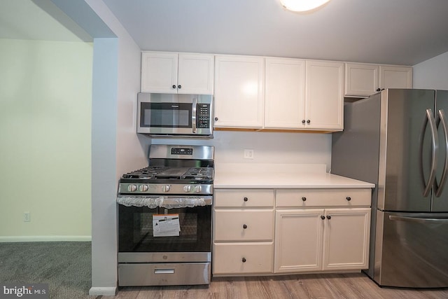 262 Drummers Ln Unit 262, Wayne, PA 19087 - kitchen featuring stainless steel appliances, light countertops, and white cabinetry