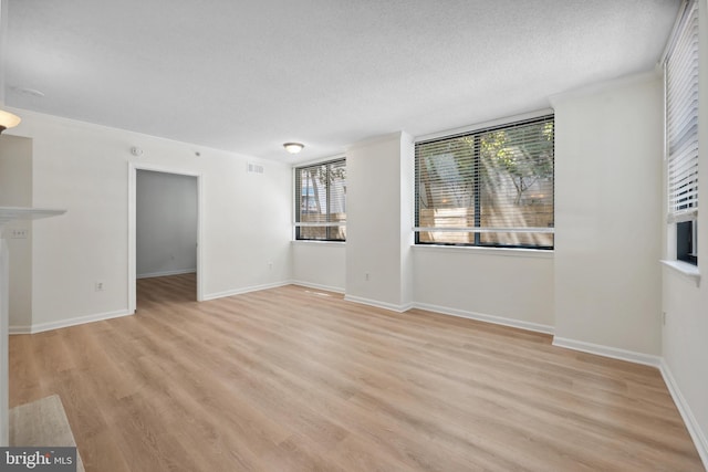 3830 9th St N Unit 110W, Arlington, VA 22203 - unfurnished living room with a textured ceiling and light wood finished floors