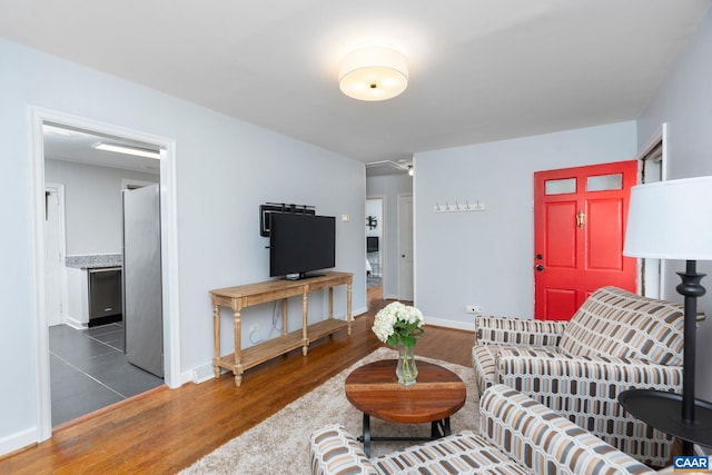 living area with wood finished floors and baseboards