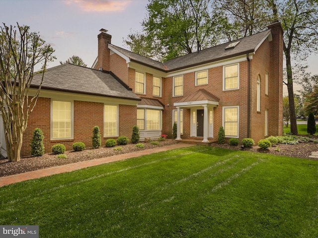7287 Evans Mill Rd, Mclean, VA 22101 - view of front facade with a chimney, a front lawn, brick siding, and a shingled roof