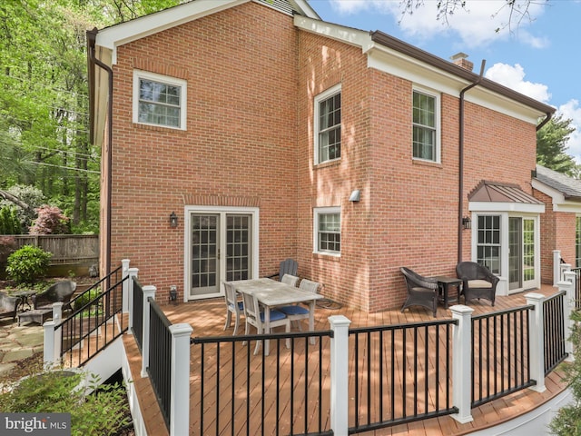 7287 Evans Mill Rd, Mclean, VA 22101 - back of house with a wooden deck, brick siding, outdoor dining area, and fence