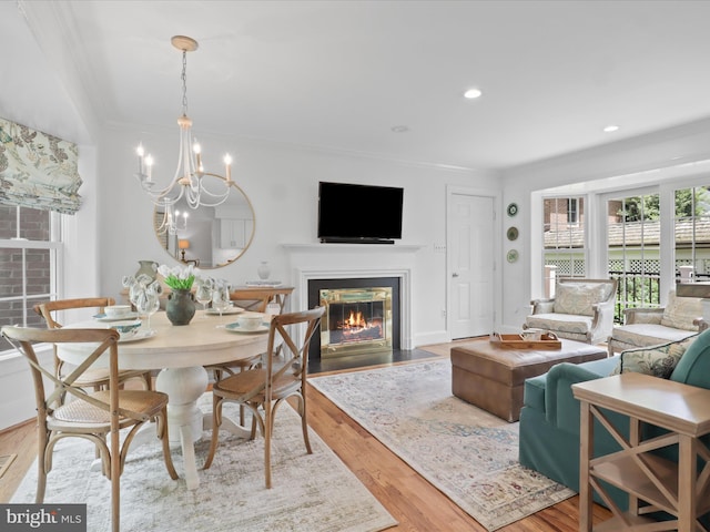 7287 Evans Mill Rd, Mclean, VA 22101 - dining area with ornamental molding, a fireplace with flush hearth, wood finished floors, a chandelier, and recessed lighting