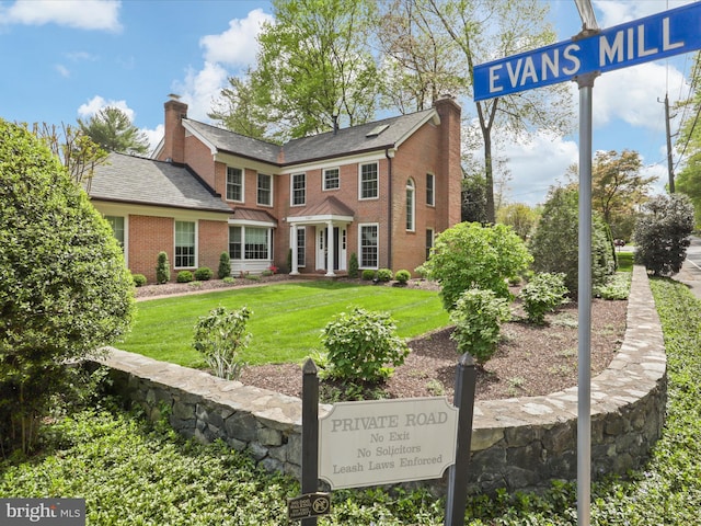 7287 Evans Mill Rd, Mclean, VA 22101 - exterior view of a chimney, brick siding, and a downspout
