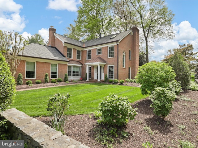 7287 Evans Mill Rd, Mclean, VA 22101 - view of front facade featuring a chimney, brick siding, and a front yard