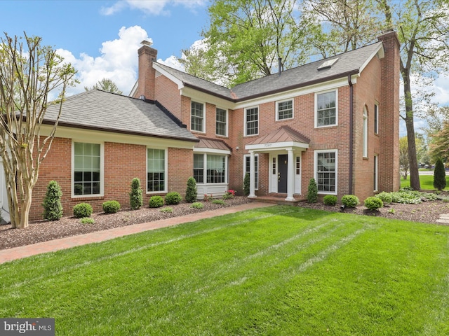 7287 Evans Mill Rd, Mclean, VA 22101 - view of front of house featuring a chimney, a front lawn, and brick siding