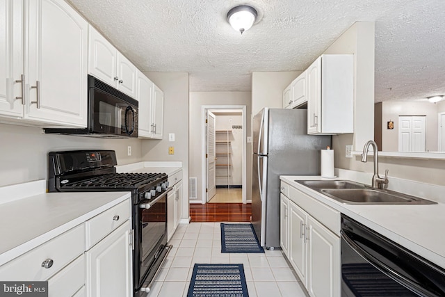 8357 Cypress Mill Rd Unit 8357, Nottingham, MD 21236 - kitchen with black appliances, a sink, white cabinets, light countertops, and a textured ceiling