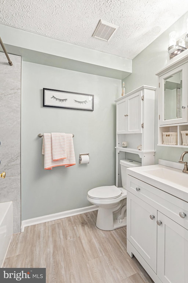 8357 Cypress Mill Rd Unit 8357, Nottingham, MD 21236 - full bathroom featuring wood finished floors, toilet, a textured ceiling, and vanity