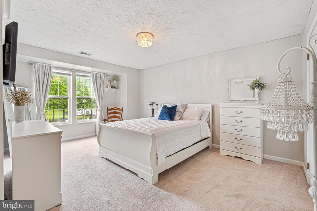 8357 Cypress Mill Rd Unit 8357, Nottingham, MD 21236 - bedroom featuring light carpet, a textured ceiling, baseboards, and a chandelier