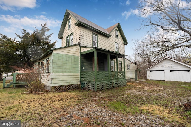 615 S New York Rd, Absecon, NJ 08205 - view of home's exterior featuring a porch, an outdoor structure, and a detached garage