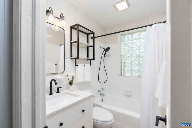 bathroom with shower / bath combo with shower curtain, tile walls, toilet, and vanity