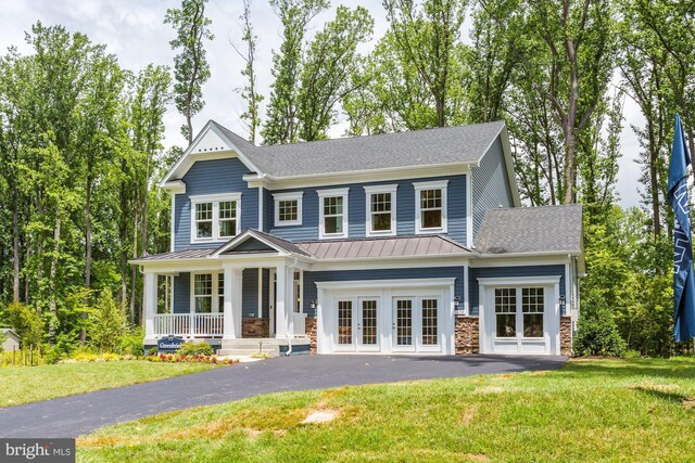 1712 Copperleaf Blvd, Hanover, MD 21076 - view of front of property featuring a standing seam roof, a porch, asphalt driveway, french doors, and a front yard